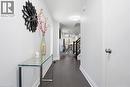 Entrance hallway featuring dark tile flooring, white baseboards, and a white interior door with brushed nickel hardware - 7 Upper Mercer Street Unit# G30, Kitchener, ON  - Indoor Photo Showing Other Room 