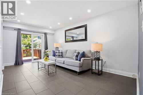 Spacious room featuring large format tile flooring, recessed lighting, and a glass sliding door opening to an outdoor deck - 7 Upper Mercer Street Unit# G30, Kitchener, ON - Indoor Photo Showing Living Room
