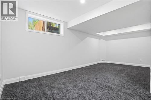 Spacious room featuring neutral paint, gray carpeting, a single window, white trim, and recessed ceiling lighting - 7 Upper Mercer Street Unit# G30, Kitchener, ON - Indoor Photo Showing Other Room
