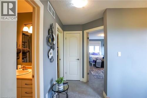 Hallway featuring carpet flooring, overhead lighting, and white trim - 365 Poldon Drive, Norwich, ON 