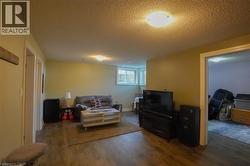 Lower-level space featuring wood-finish flooring, recessed lighting, and light-toned walls - 