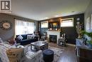 Living area featuring wood-finish flooring, a white mantel fireplace, and recessed ceiling lighting - 365 Poldon Drive, Norwich, ON 