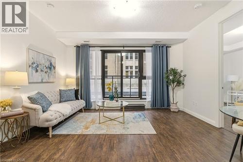 Bright open-concept living area with balcony - 112 King Street E Unit# 408, Hamilton, ON 
