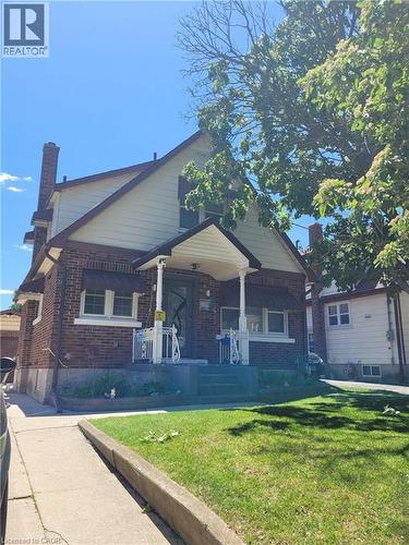 Brick exterior with a gabled roofline and light-colored siding - 153 Arnold Street, Kitchener, ON 