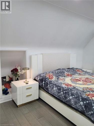 Wood-finish flooring with a sloped ceiling and recessed nook - 153 Arnold Street, Kitchener, ON 