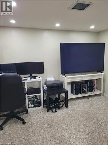 Wall-to-wall carpeting in a neutral tone, complemented by recessed ceiling lighting - 153 Arnold Street, Kitchener, ON 
