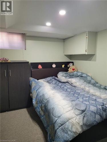 Room featuring recessed lighting, a built-in wall cabinet, and a window with blinds - 153 Arnold Street, Kitchener, ON 