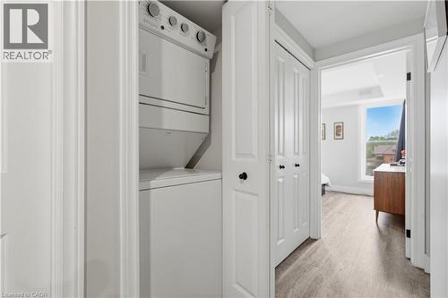 Dedicated laundry closet featuring a stacked washer and dryer - 389 Dundas Street, Woodstock, ON 
