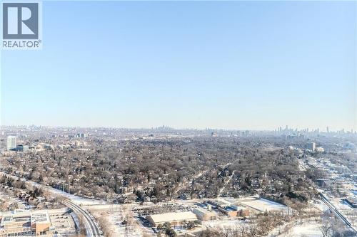Expansive aerial perspective showcasing a broad urban landscape with a distant city skyline - 7 Mabelle Avenue Unit# Ph07, Toronto, ON 