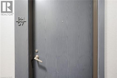 Entry door with a wood-grain finish and modern hardware - 7 Mabelle Avenue Unit# Ph07, Toronto, ON 