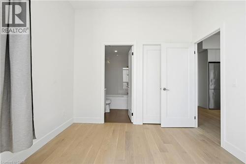 Light wood-finish flooring complements crisp white walls and baseboards - 7 Mabelle Avenue Unit# Ph07, Toronto, ON 