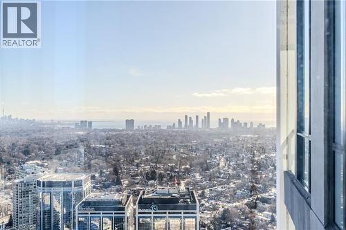 Expansive cityscape from a high-rise window, featuring a distant skyline and a wide expanse of urban landscape - 7 Mabelle Avenue Unit# Ph07, Toronto, ON 