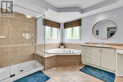 Huge soaker tub and glass enclosed shower. - 