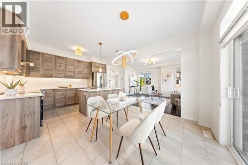 Dining room featuring light tile patterned flooring and a chandelier - 1 Bee Crescent, Brantford, ON 