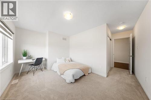 Bedroom with an office area, light carpet, and a closet - 1 Bee Crescent, Brantford, ON 
