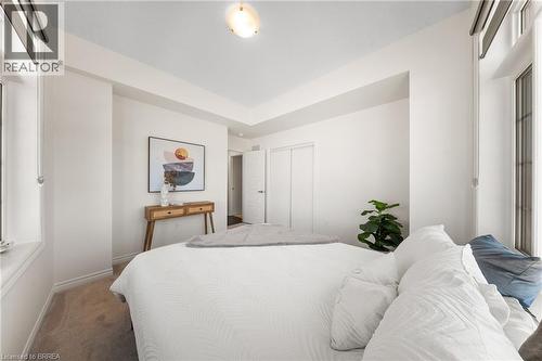 Carpeted bedroom featuring a closet and baseboards - 1 Bee Crescent, Brantford, ON 
