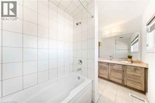 Full bathroom featuring light tile patterned floors, vanity, and tub / shower combination - 1 Bee Crescent, Brantford, ON 