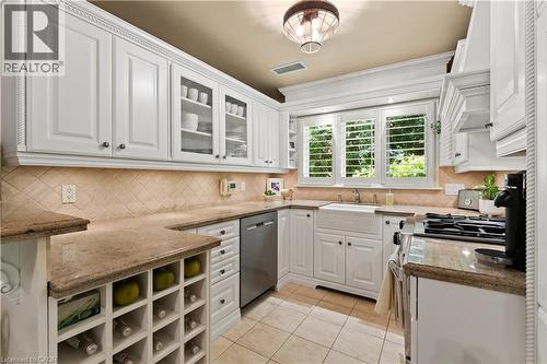 Maytag fridge and dishwasher. Wine rack. Heated floor. Jenn-aire dual fuel gas/electric range. Granite counter. Plantation shutters. Kohler sink. - 3040 First Street, Burlington, ON - Indoor Photo Showing Other Room