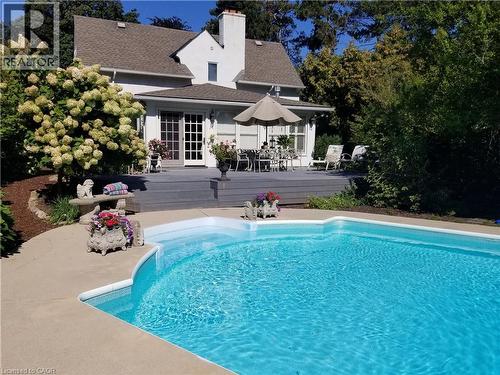 18 by 36 vinyl pool, concrete surround. Pump and filter cartridges (replaced 2024). Pool shed. 2024 photo showing hydrangea in bloom - 3040 First Street, Burlington, ON - Outdoor