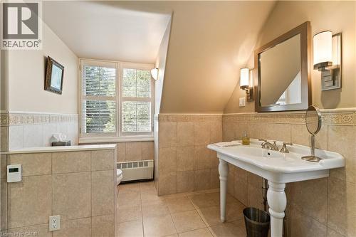 Tiled wall and floor. Heated floor. All baseboard heating, except mudroom and laundry are connected to the gas boiler. - 3040 First Street, Burlington, ON - Indoor Photo Showing Bathroom