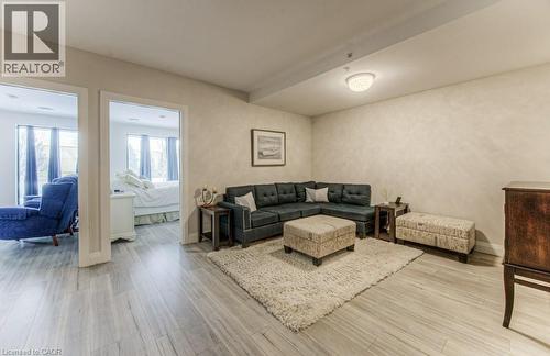 Spacious room featuring wood-look flooring and light-toned walls - 5 Wake Robin Drive Unit# 107, Kitchener, ON 