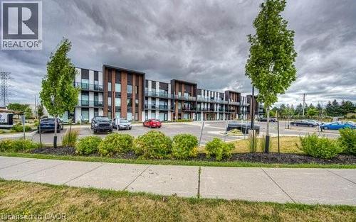 Contemporary building with dark and light paneling and brick accents - 5 Wake Robin Drive Unit# 107, Kitchener, ON 