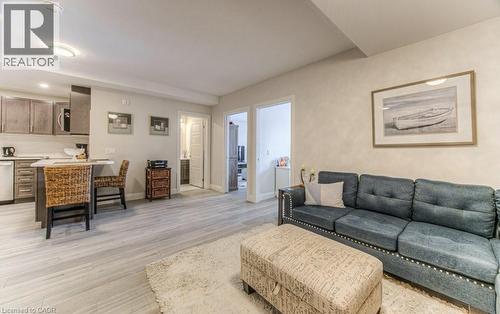 Open-concept living area featuring light wood-finish flooring - 5 Wake Robin Drive Unit# 107, Kitchener, ON 