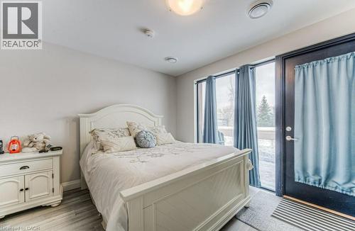 Light-toned walls with recessed lighting and wood-finish flooring - 5 Wake Robin Drive Unit# 107, Kitchener, ON 