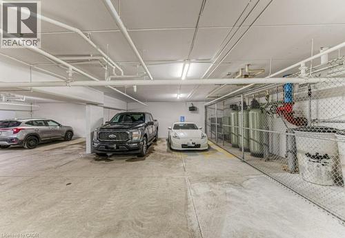 Underground parking area featuring concrete flooring and a white painted ceiling with exposed pipework - 5 Wake Robin Drive Unit# 107, Kitchener, ON 