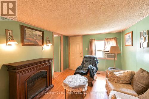 Living Room with electric fireplace (AI enhanced) - 3427 Coronation Avenue, Severn (West Shore), ON 