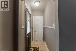Doorway to outside with light tile patterned floors and tile walls - 