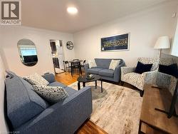 Living area featuring light wood-type flooring and crown molding - 