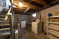 Basement featuring sink and washing machine and clothes dryer - 