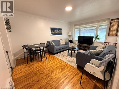 Living room with hardwood / wood-style flooring and baseboards - 501 Upper Wellington Street, Hamilton, ON 