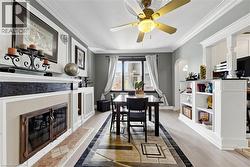 Dining area featuring a fireplace with a tiled hearth and a decorative mantel - 