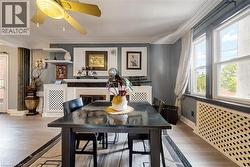Spacious interior featuring wood-finish flooring and a decorative fireplace with a classic mantel - 
