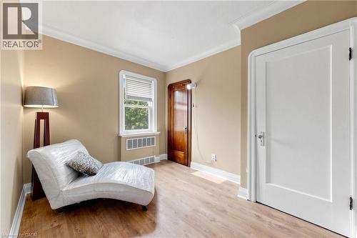 Room featuring wood-finish flooring, white baseboards, and crown molding - 287 Courtland Avenue E, Kitchener, ON 