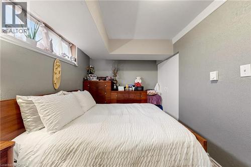 Bedroom featuring a wood-finish headboard and built-in closet - 287 Courtland Avenue E, Kitchener, ON 