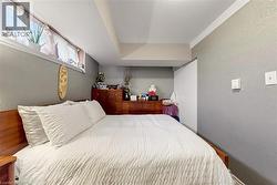 Bedroom featuring a wood-finish headboard and built-in closet - 