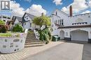 White stucco exterior with an attached garage and arched entryways - 287 Courtland Avenue E, Kitchener, ON 