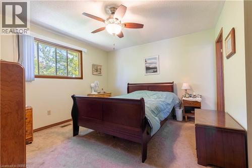 Bedroom featuring a ceiling fan with integrated lighting, wood-trim window, and light-toned wall paint - 12 Spartan Drive, Brantford, ON - Indoor Photo Showing Bedroom