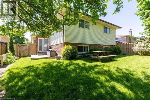 Expansive green lawn with mature trees providing partial shade - 12 Spartan Drive, Brantford, ON - Outdoor
