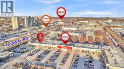 Retail plaza with extensive parking, featuring multiple commercial buildings and proximity to Fairway Road S - 