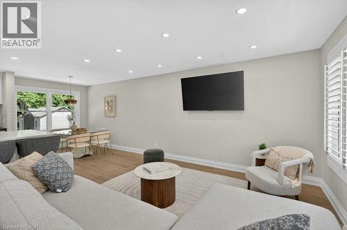 Open-concept living area with light wood-finish flooring, recessed lighting, and crisp white trim - 603 Cornick Drive, Burlington, ON 