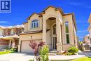 Stucco exterior with stone accents and a prominent arched entryway - 92 Desoto Drive, Hamilton, ON  - Outdoor With Facade 