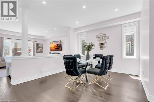 Dining area featuring dark wood-finish flooring, recessed lighting, and bright white trim - 92 Desoto Drive, Hamilton, ON - Indoor Photo Showing Dining Room