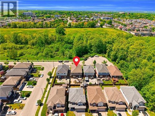 Aerial perspective of a residential street with detached homes featuring varied architectural styles and pitched roofs - 92 Desoto Drive, Hamilton, ON - Outdoor With View