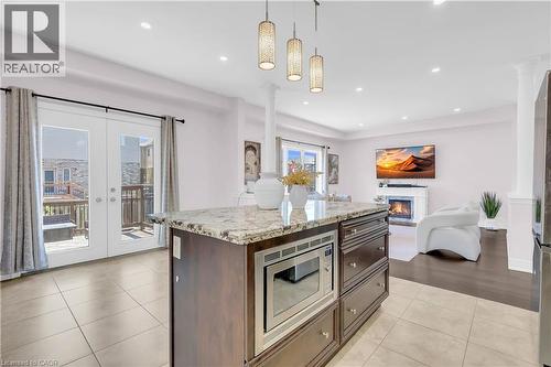 Spacious kitchen island featuring a granite countertop and built-in microwave - 92 Desoto Drive, Hamilton, ON - Indoor Photo Showing Kitchen With Upgraded Kitchen