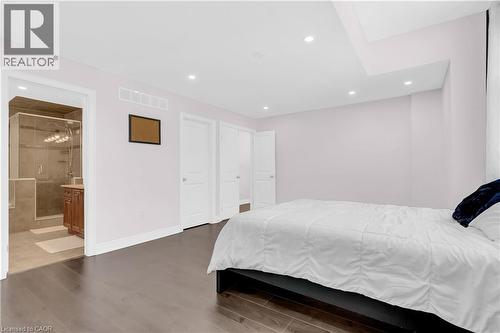 Spacious bedroom featuring dark wood-finish flooring, recessed lighting, and a neutral wall color - 92 Desoto Drive, Hamilton, ON - Indoor Photo Showing Bedroom