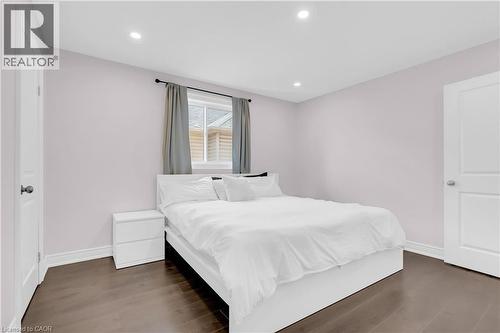 Bedroom featuring wood-finish flooring, recessed lighting, and a window with a dark curtain rod - 92 Desoto Drive, Hamilton, ON - Indoor Photo Showing Bedroom